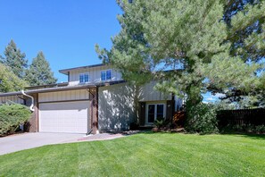 A two-story residential house with a garage, a well-maintained lawn, and mature trees. - Cherry Creek Reservoir Trail Access On-Site! (Englewood)