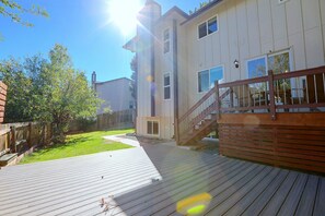 A wooden deck with a wooden fence and a staircase leading to a building. - Cherry Creek Reservoir Trail Access On-Site! (Englewood)