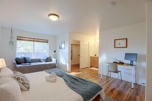 A modern bedroom with a bed, a desk, and a chair. - 3 Mi to Dtwn Bend: Private Hot Tub & Yard (Bend)