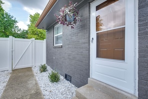 A residential house with a white garage door, a grey brick exterior, and a white picket fence. - 2-Condo Hub! 1/2 Mi to University of Dayton (Dayton)