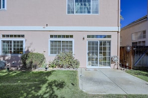 A two-story residential building with a front porch, a garage, and a well-maintained lawn. - San Jose Furnished Stay w/ Laundry (San Jose)