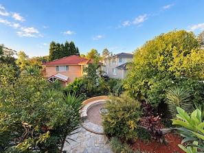 A residential area with two houses, a stone pathway, and various plants. - Resort-style Executive and Family Retreat (Hornsby)