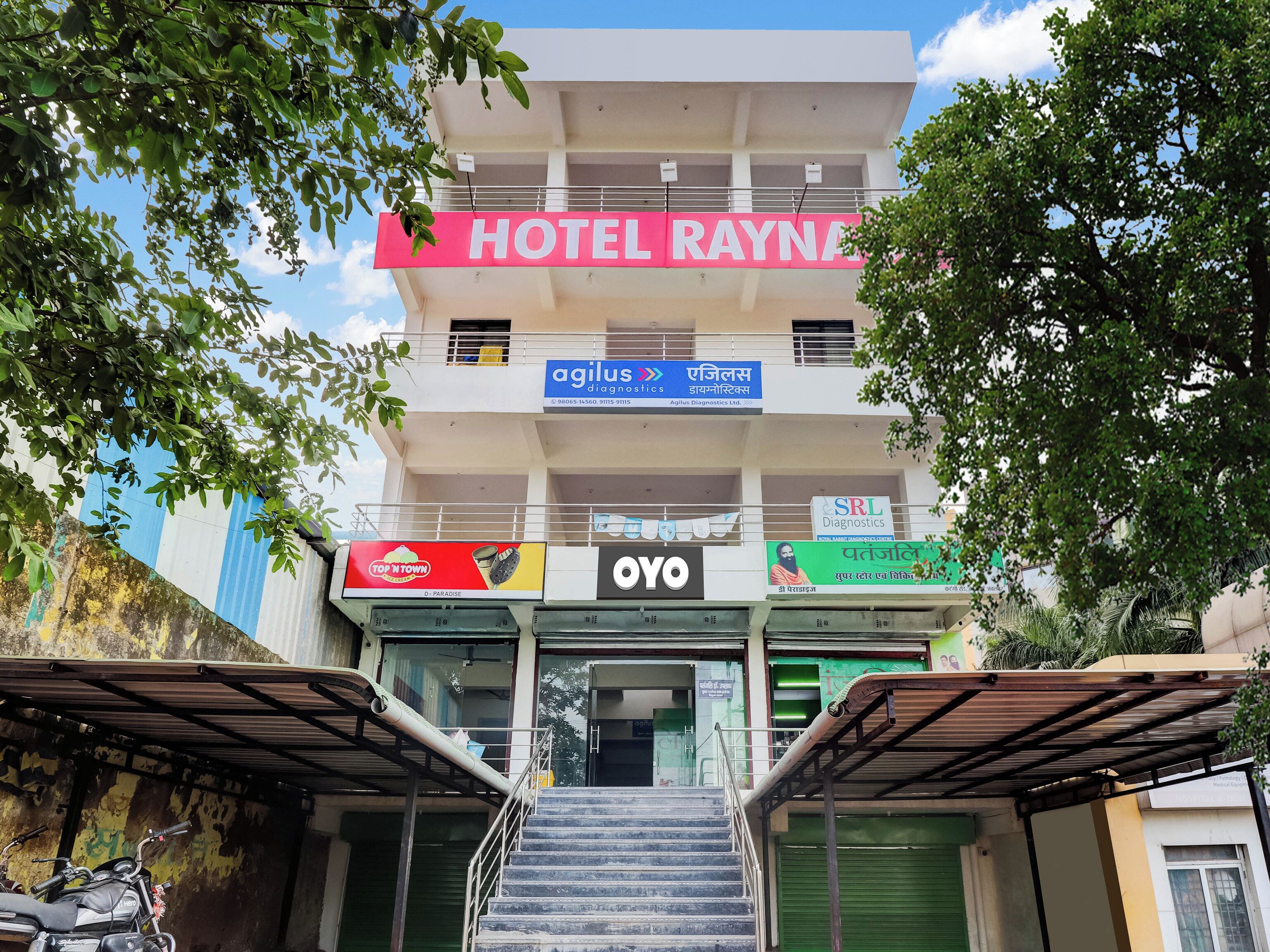 A multi-story building with a sign for 'HOTEL RAYNA' at the top.