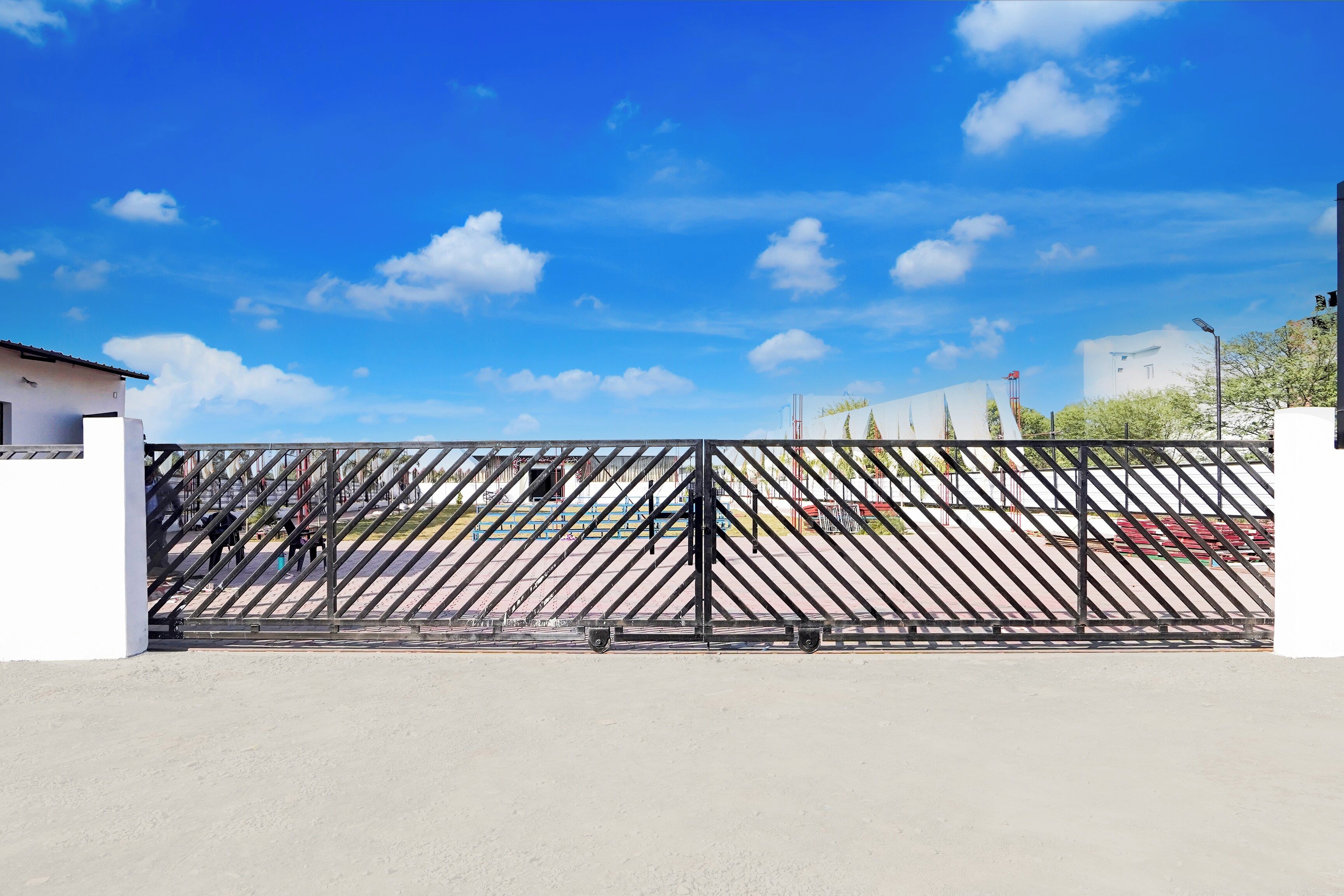 A gated area with a clear sky and a building in the background.