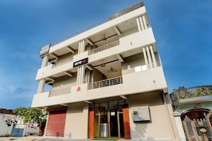 A multi-story building with a sign for 'Hotel Value' and 'OYO' indicating a hotel and a restaurant. - Hotel O by OYO Value (Jabalpur)