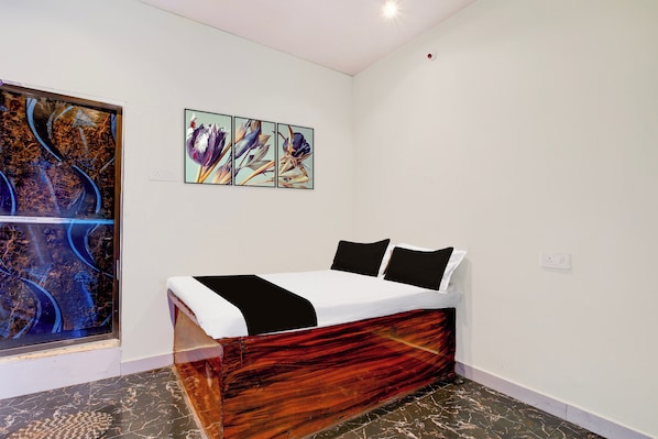 A bedroom with a bed, a wall-mounted artwork, and a marble floor. - Hotel O by OYO Virashat (Sihora)