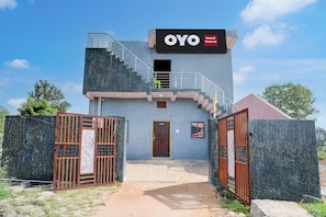 A two-story building with a sign reading 'OYO Hotel Virasat.'