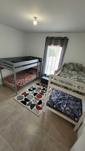 A room with bunk beds, a window with curtains, and a ceiling light. - New Listing (Roujan)
