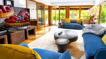 A modern living room with a television, sofas, and a coffee table.