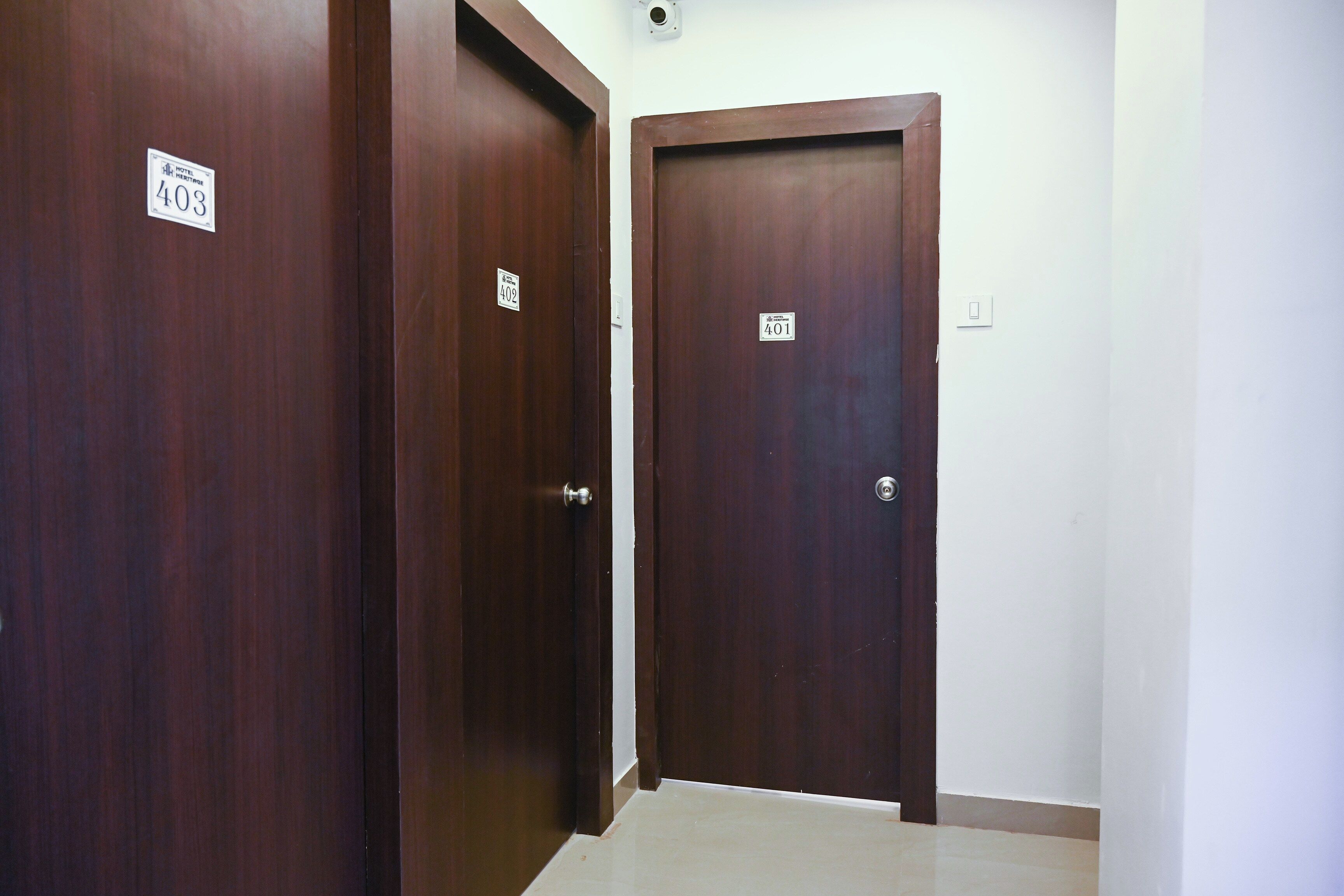 A hallway with three wooden doors, each marked with a number.