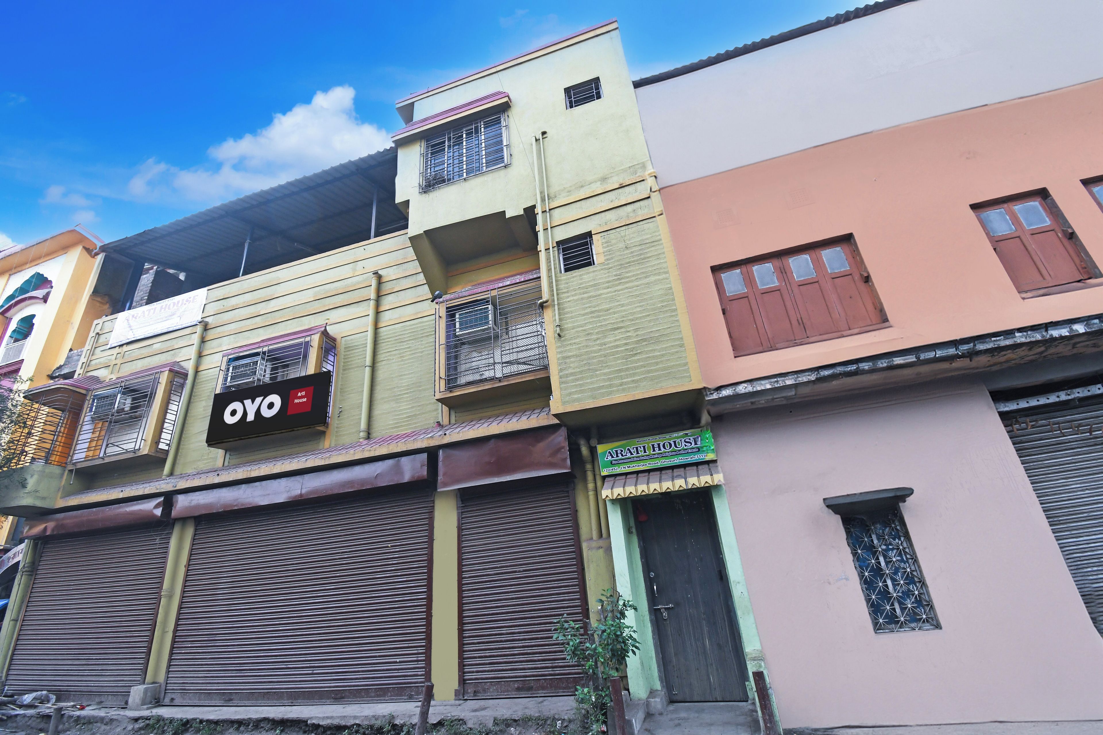 A multi-story building with a sign for 'OYO Art House' on the second floor.