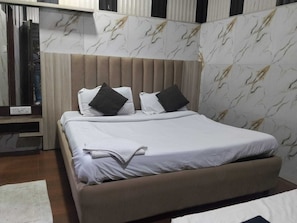Ein Bett mit Kopfteil, Kissen und Decke.
