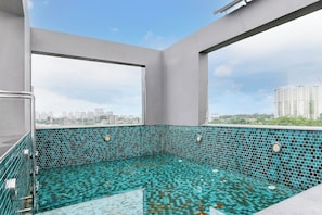 A rooftop swimming pool with a cityscape view. - Collection O Water View Residency (Barasat)