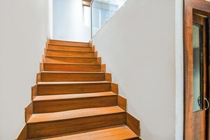 A wooden staircase leading to a door.
