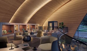 Ein modernes Interieur mit gewölbter Decke, Sitzbereichen und Blick durch eine Glaswand.