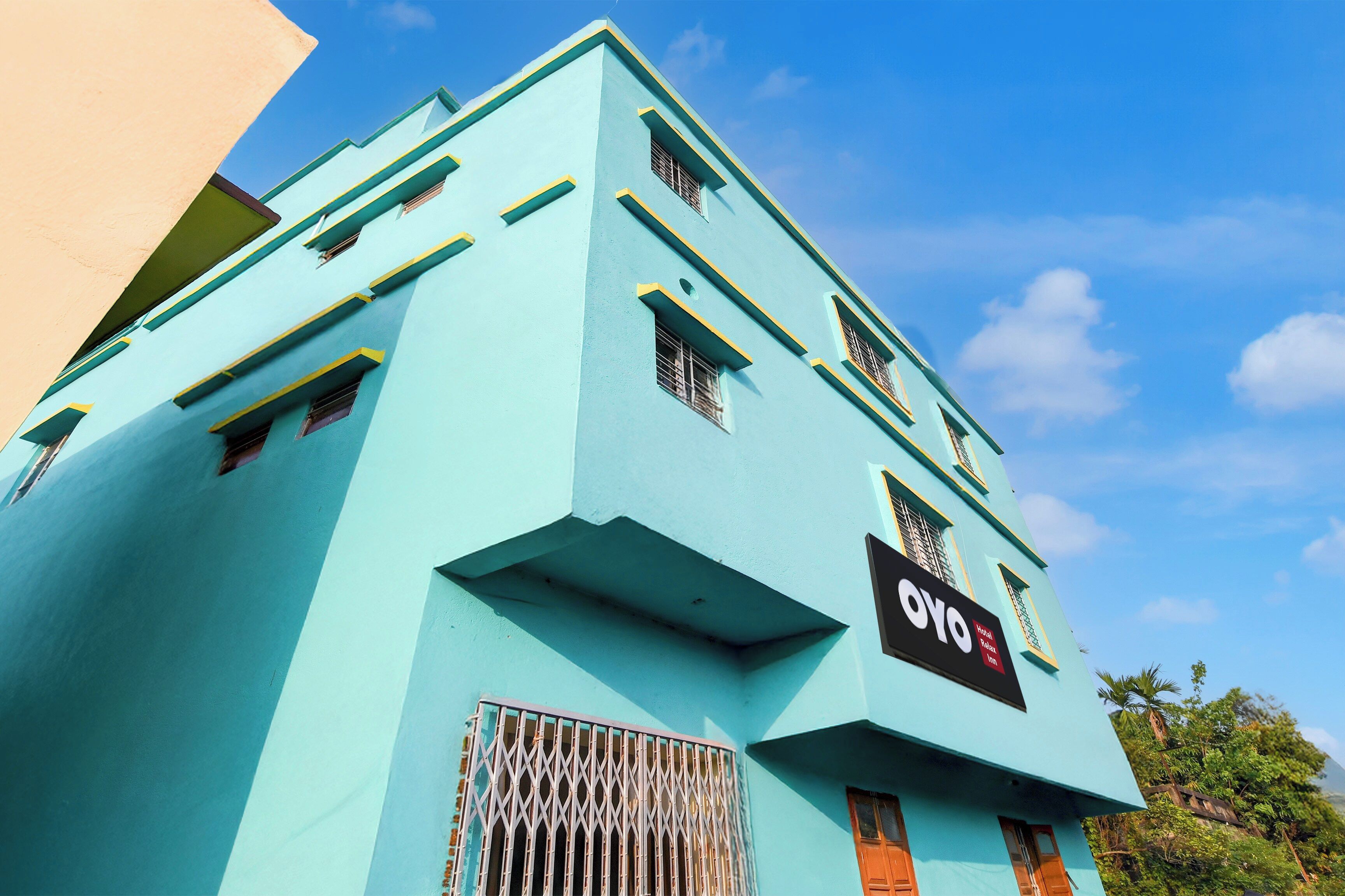 A multi-story building with a prominent sign for 'OYO Hotel Relax Inn'.