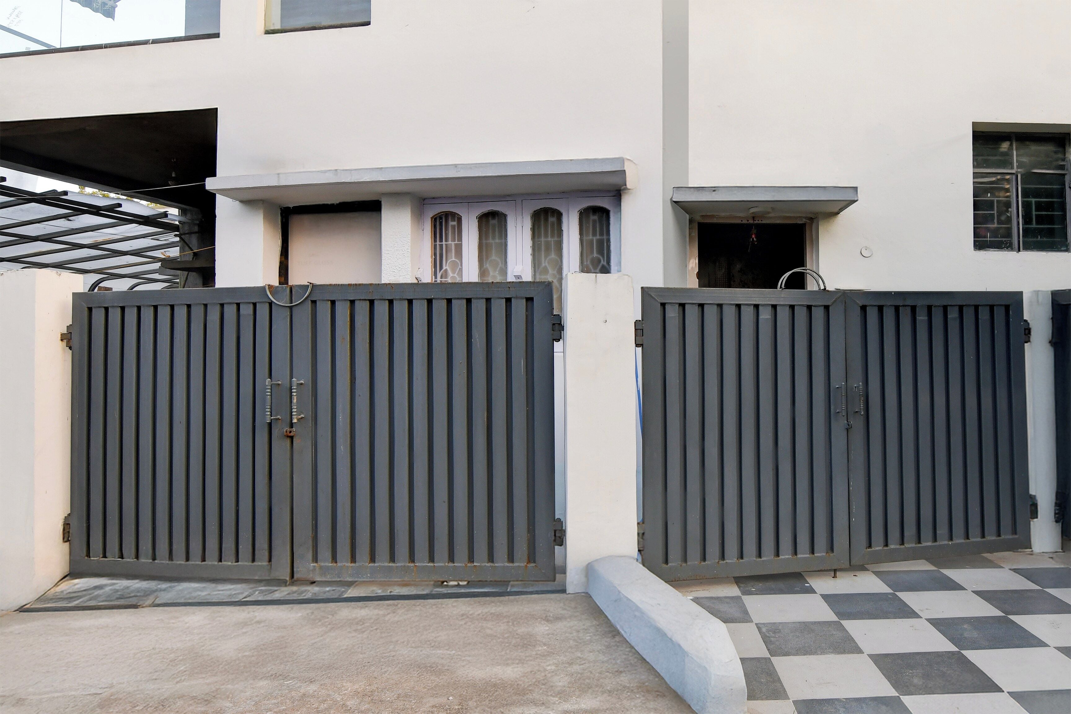 A gated entrance with a checkered floor pattern.