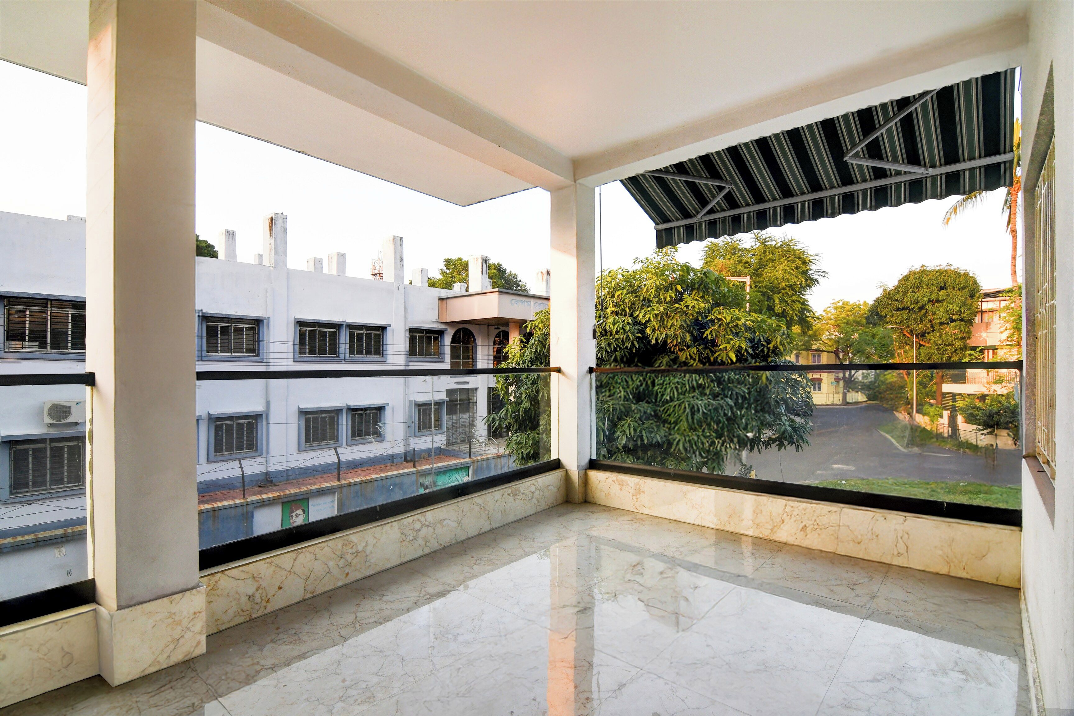 A balcony with a view of a street and buildings.
