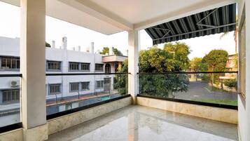 A balcony with a view of a street and buildings.