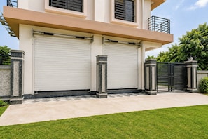 A modern two-story building with a closed garage door and a gated entrance. - Hotel O Golden Aura Near Netaji Subhash (Kolkata)