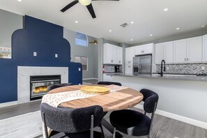 A modern kitchen with white cabinets, a built-in oven, and a black ceiling fan. - Elegant Menifee Lakes Retreat with Pool and Spa (Menifee)