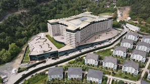 A large hotel complex with multiple buildings, a parking area, and surrounding greenery. - Sarot Thermal Vadi Tatil Köyü (Mudurnu)