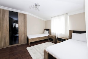 A bedroom with two beds, a wardrobe, a mirror, and a chandelier. - Sarot Thermal Vadi Tatil Köyü (Mudurnu)