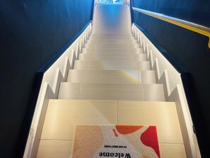 Un escalier avec un paillasson à sa base.