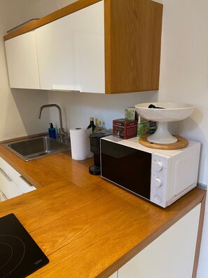 A compact kitchen with a microwave oven, a sink, and a small countertop. - New Listing (Firenze)
