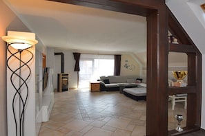 A living room with a sofa, a coffee table, and a lamp. - Holiday apartment in Waltershausen with Wi-Fi (Waltershausen)
