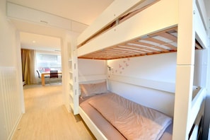 A bunk bed room with a desk and chair in the background. - House Poseidon - Apartment 1.1 (Wangerooge)