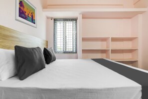 A bedroom with a bed, pillows, a window with blinds, and a painting on the wall. - Hotel O 11 Eleven (Hyderabad)