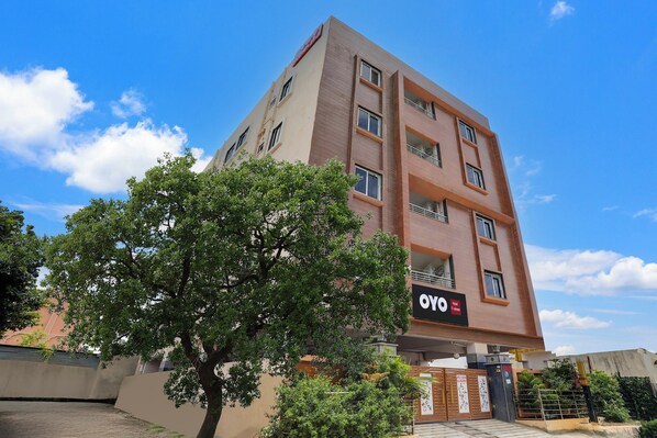 A multi-story hotel building with a sign indicating it has 11 bedrooms.