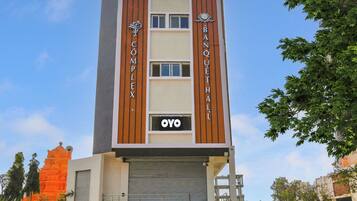 A multi-story building with signage for 'Complex' and 'Banquet Hall' indicating a hotel or event space.