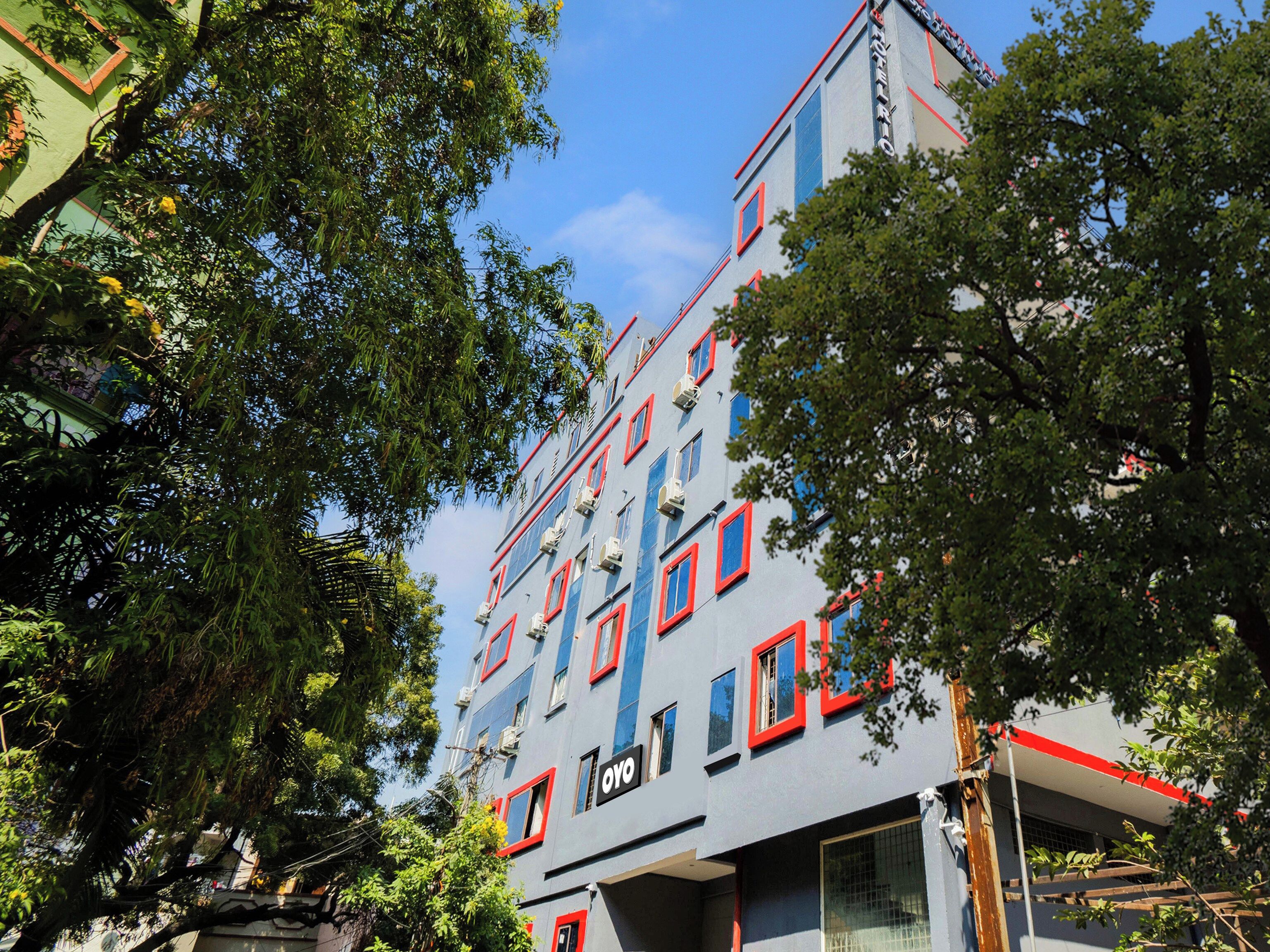 A multi-story building with a modern architectural design, featuring a series of windows and balconies.