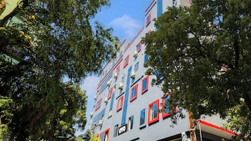 A multi-story building with a modern architectural design, featuring a series of windows and balconies.