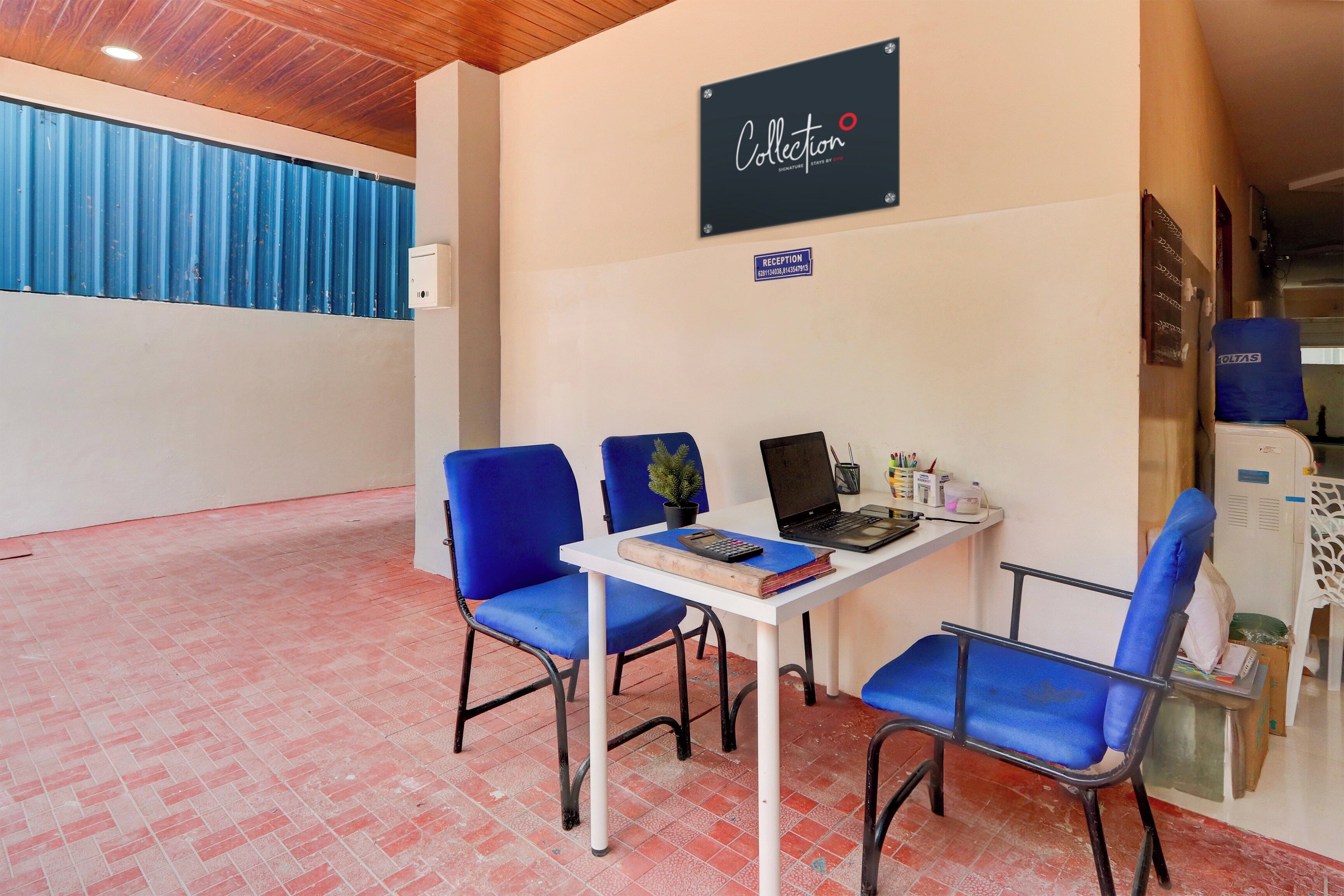 A reception area with a sign reading 'Collection Signature Stays by 2019', a reception desk, and blue chairs.