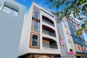 A multi-story building with a sign for 'Sri Balaji Luxury Rooms' and another sign for 'Collection.' - Super Collection O Sri Balaji Luxury (Hyderabad)
