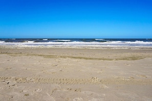 A beach with visible footprints and waves. - Residence Juliana 69 (Julianadorp)