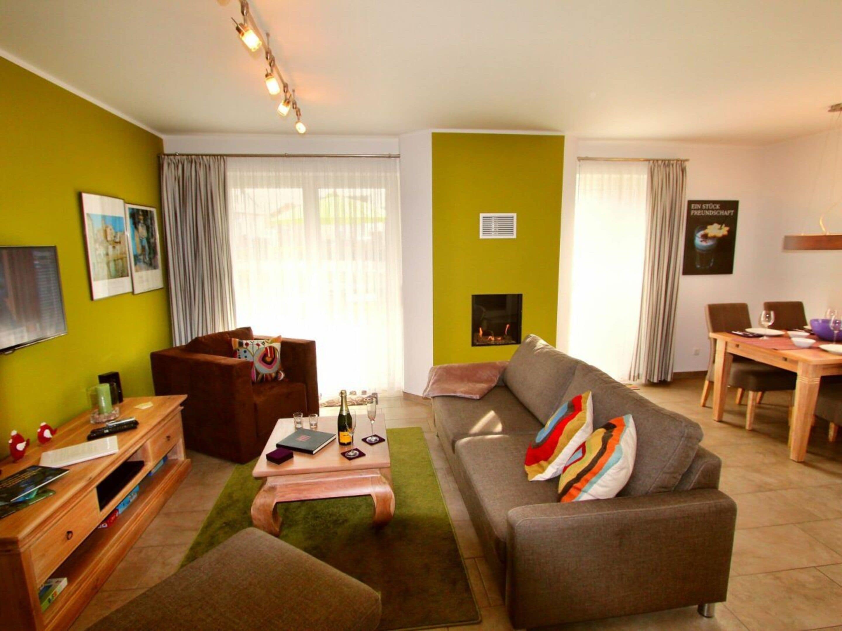 A living room with a sofa, coffee table, and a fireplace.