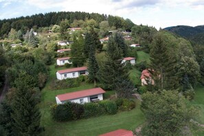 A residential area with multiple houses surrounded by dense forest. - Holiday home in Floh-Seligenthal with sauna (Floh-Seligenthal)