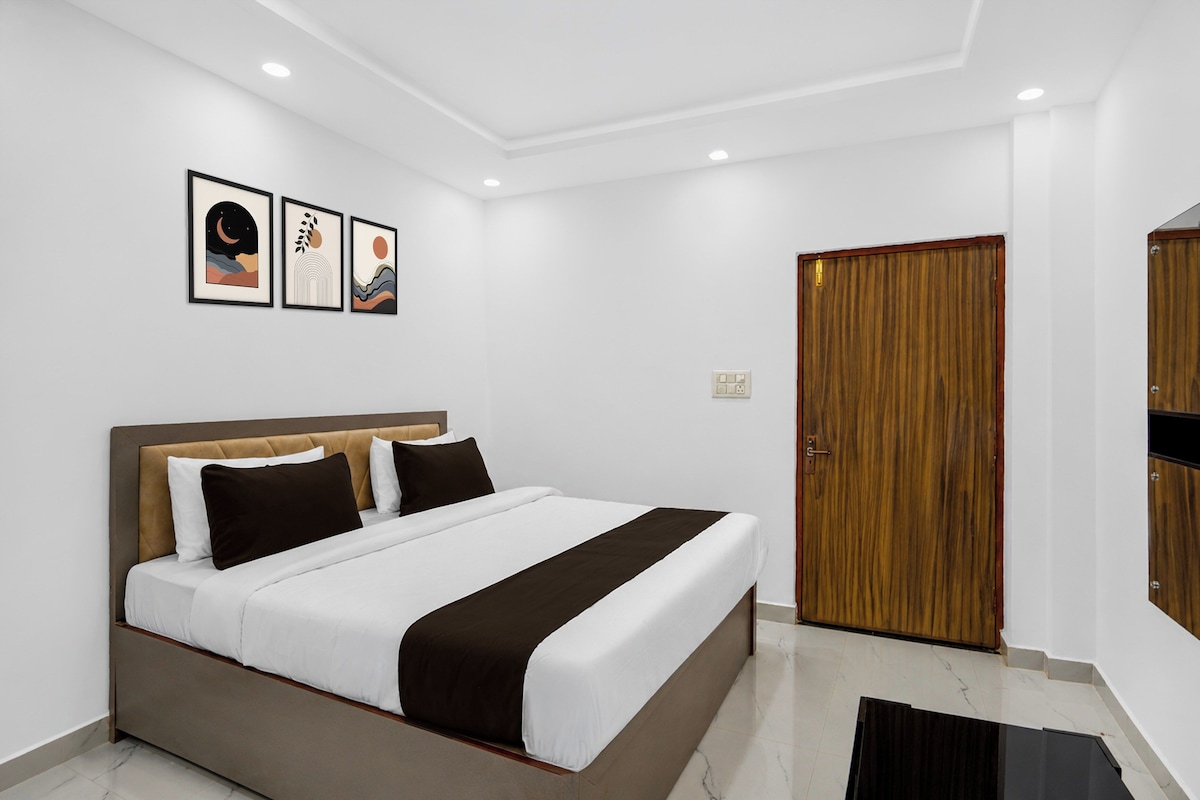 A modern bedroom with a bed, a wooden wardrobe, and a wall-mounted picture frame.
