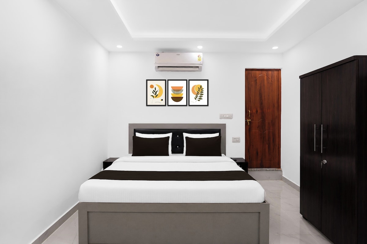 Un dormitorio moderno con una cama, un armario y tres obras de arte enmarcadas en la pared.