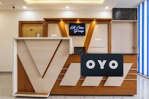 A reception desk with a large 'OYO' sign, a '101' room number, and a 'F-One Group' sign above. - Hotel O A One hotel 2 and Banquet (Lucknow)