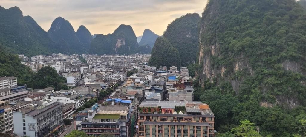 A cityscape with buildings surrounded by mountains.