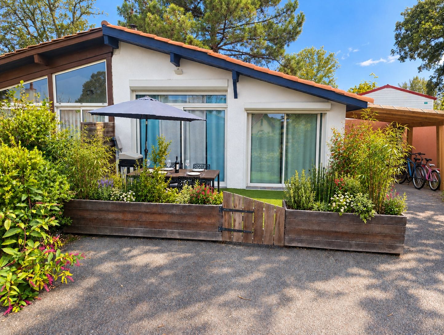 A modern house with a patio, a barbecue grill, and a bicycle parked outside.