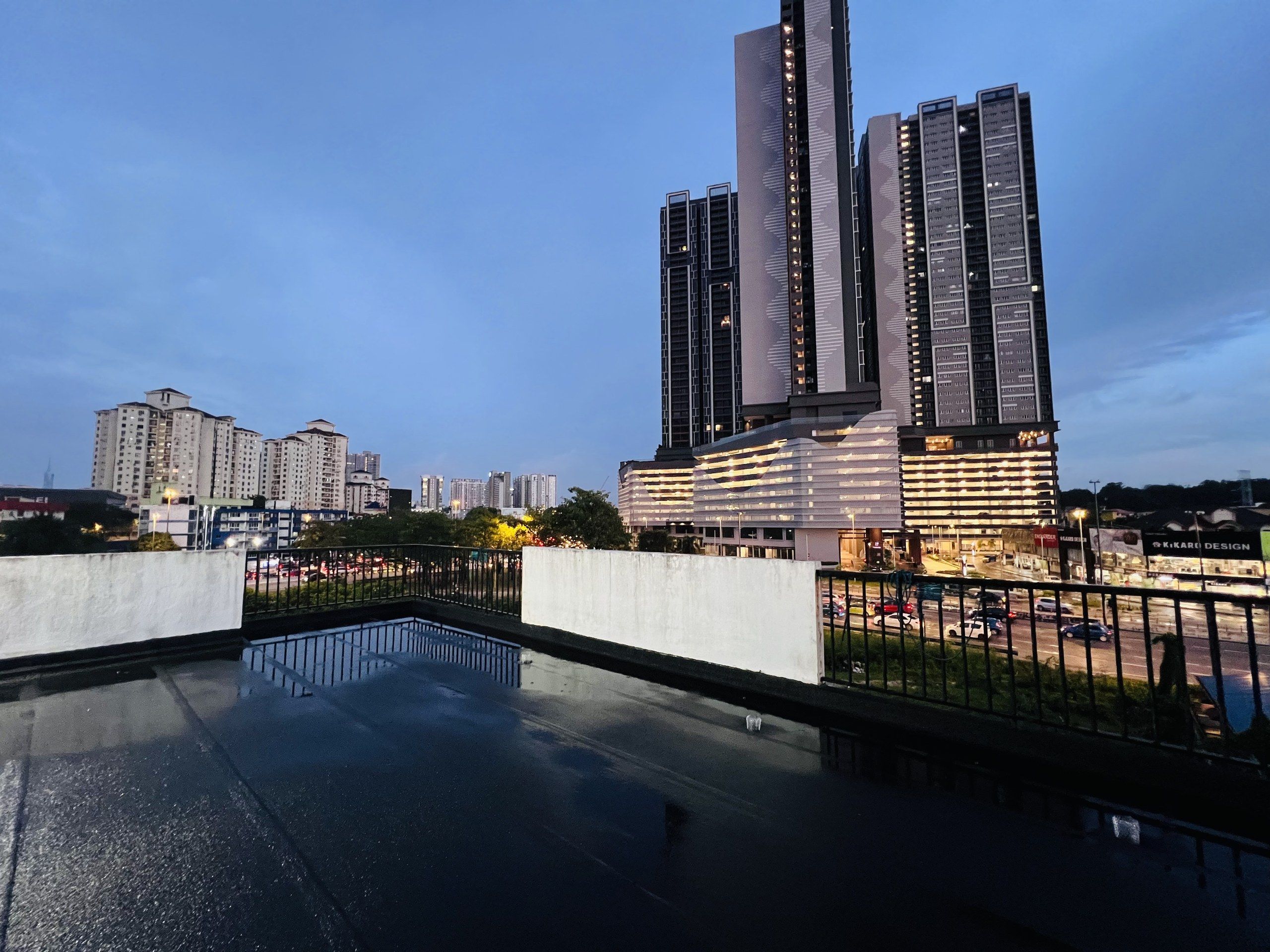 Un edificio moderno de gran altura con una piscina reflectante al frente.