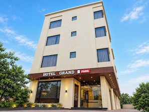 A multi-story hotel with a sign indicating 'HOTEL GRAND PARK' and a visible entrance. - Hotel O Grand Park (Amritsar)