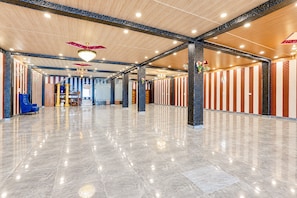 A spacious lobby with a polished marble floor, high ceilings with exposed beams, and a central staircase. - Hotel O Aurivique hotels and Banquets (Lucknow)