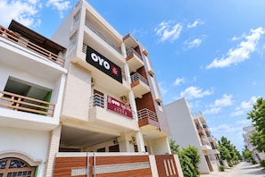 A multi-story building with balconies, a prominent 'OYO' sign, and a gated entrance. - Hotel O The Sukoon House (Lucknow)